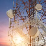 Satellite dish telecom tower at sunset